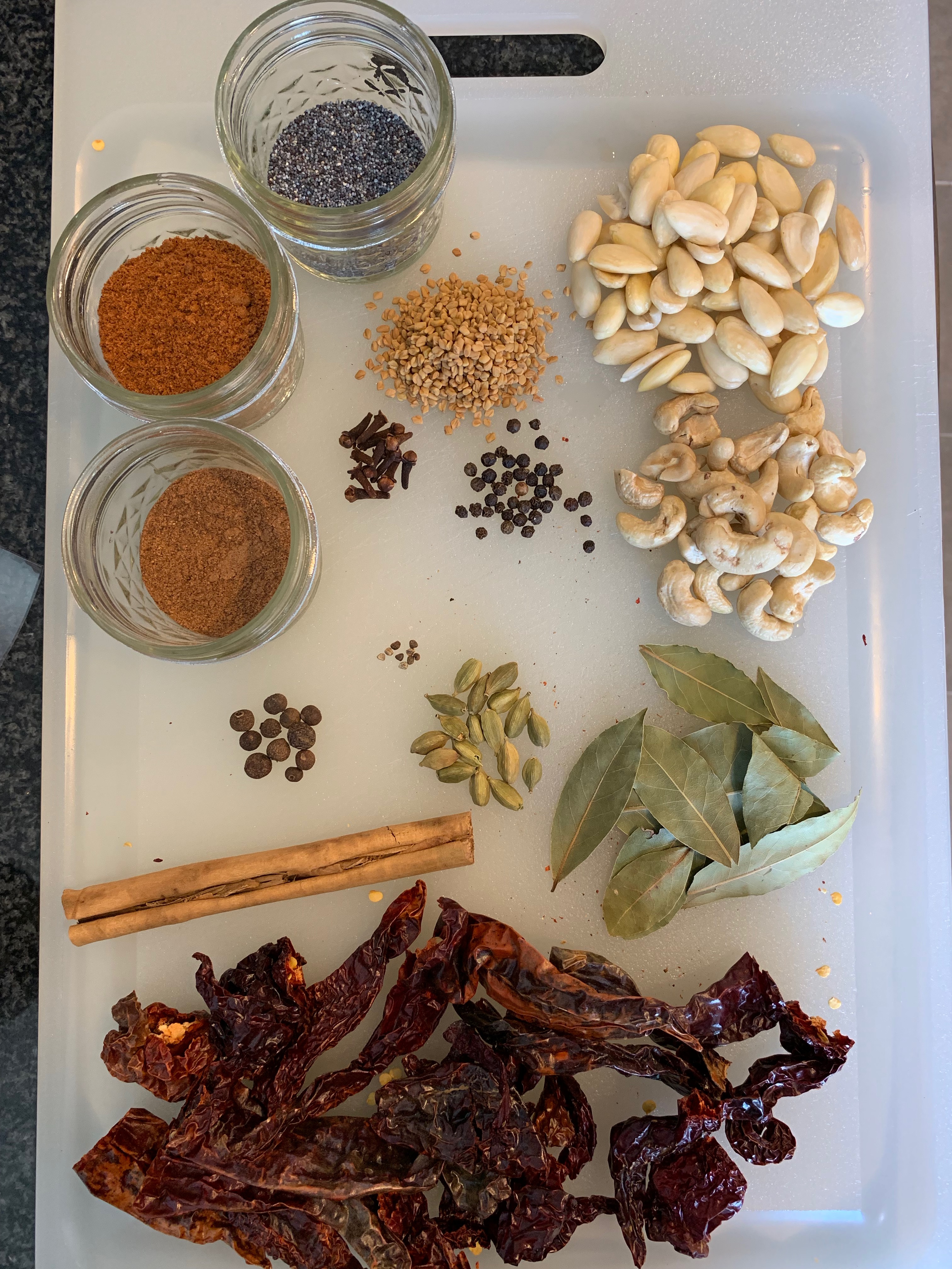 Spice blend ingredients: dried chilies, whole spices, cashews, peanuts